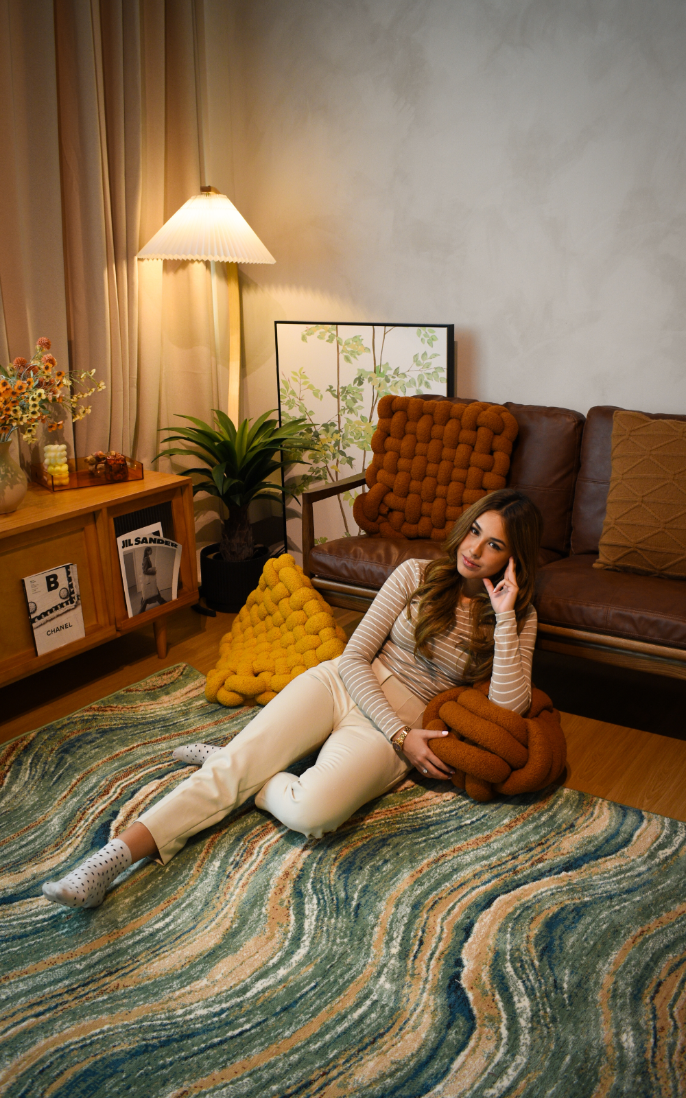 girl sitting on a beautiful green wave design carpet.