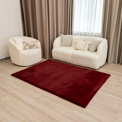 Beautiful deep red fur carpet in a stylish living room setting with white sofa, adding warmth and vibrancy to the decor.