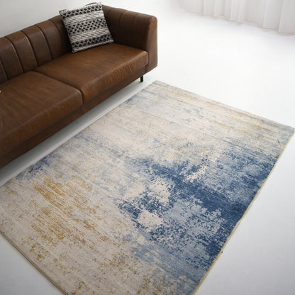 A blue and beige abstract carpet with a distressed texture, adding depth and a contemporary feel to the room.