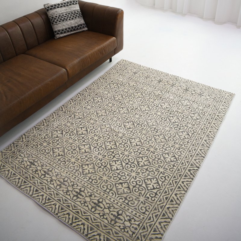 This grey carpet features an intricate ornate pattern that exudes timeless elegance and sophistication to any space.