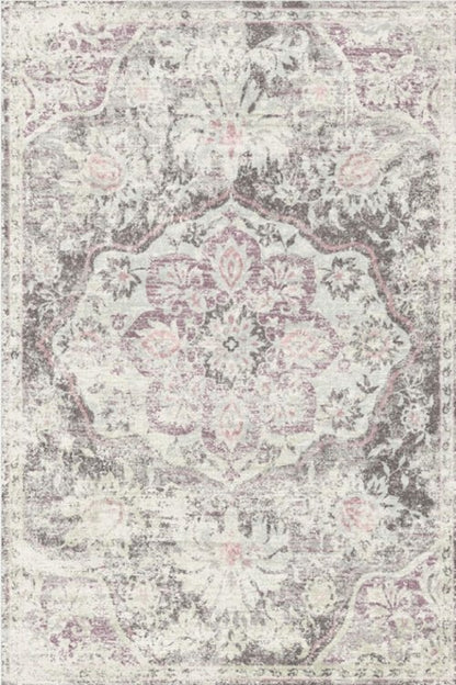 A vintage-style rug with floral patterns in shades of gray and white, giving it a look that adds character to any room.