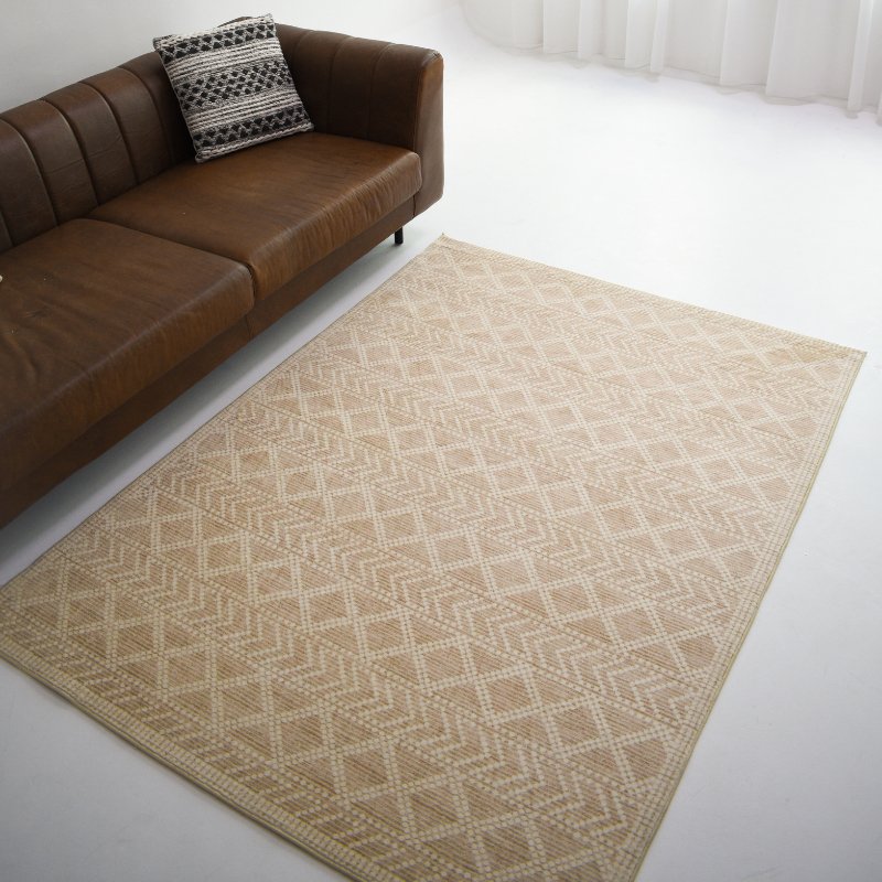 Neutral-toned carpet with intricate geometric patterns, featuring zigzag details, adding texture to a minimal design.