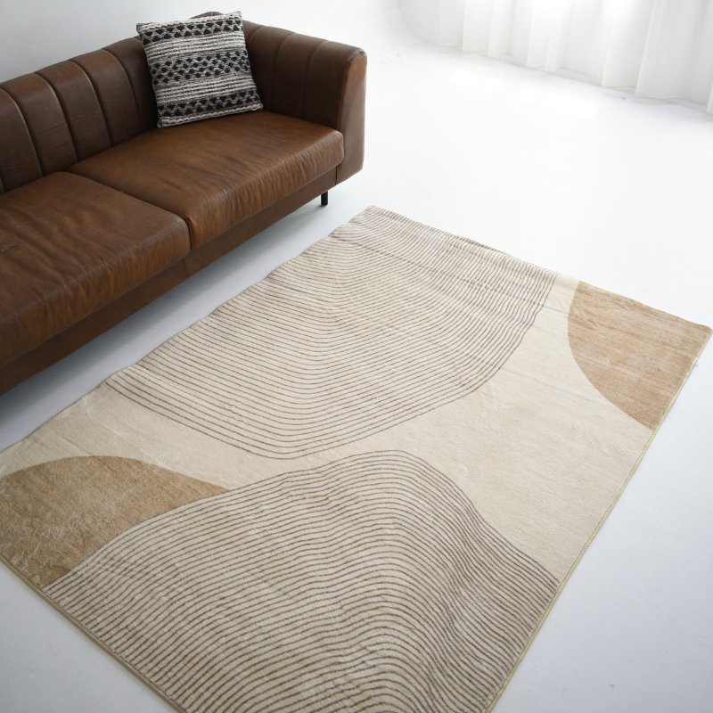 A rug featuring abstract shapes in beige and light brown tones, outlined with linear details, adding subtle a modern feel.