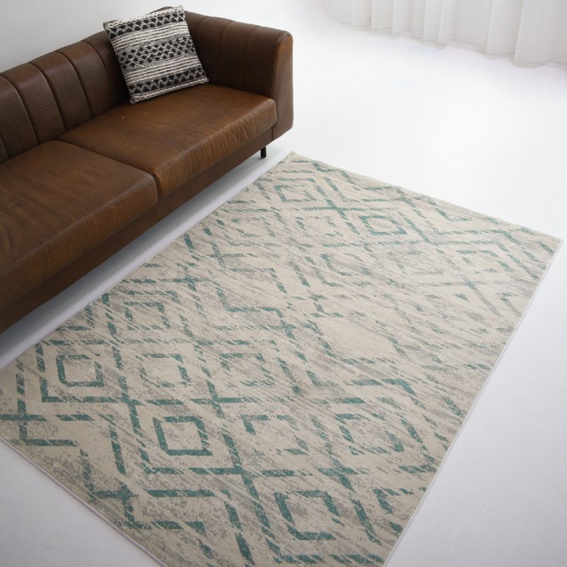 This grey carpet with a green geometric design enhances your space with subtle patterns and adds a modern touch to any room